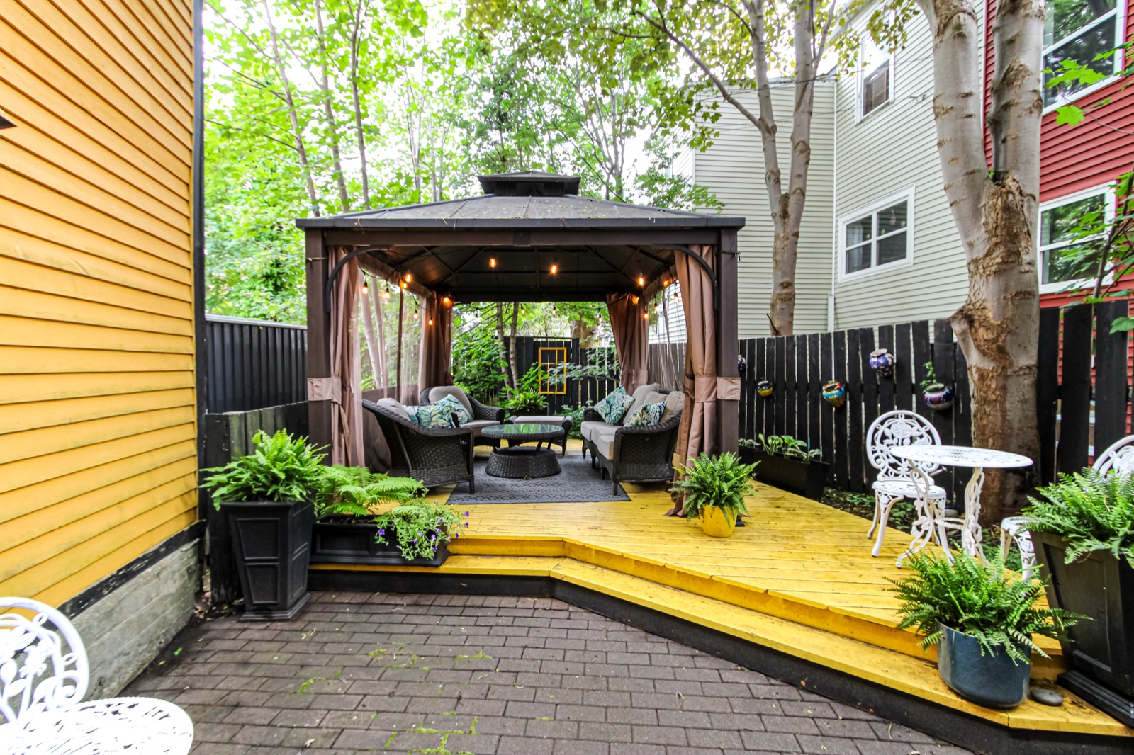 Private downtown backyard with deck, gardens and covered gazebo