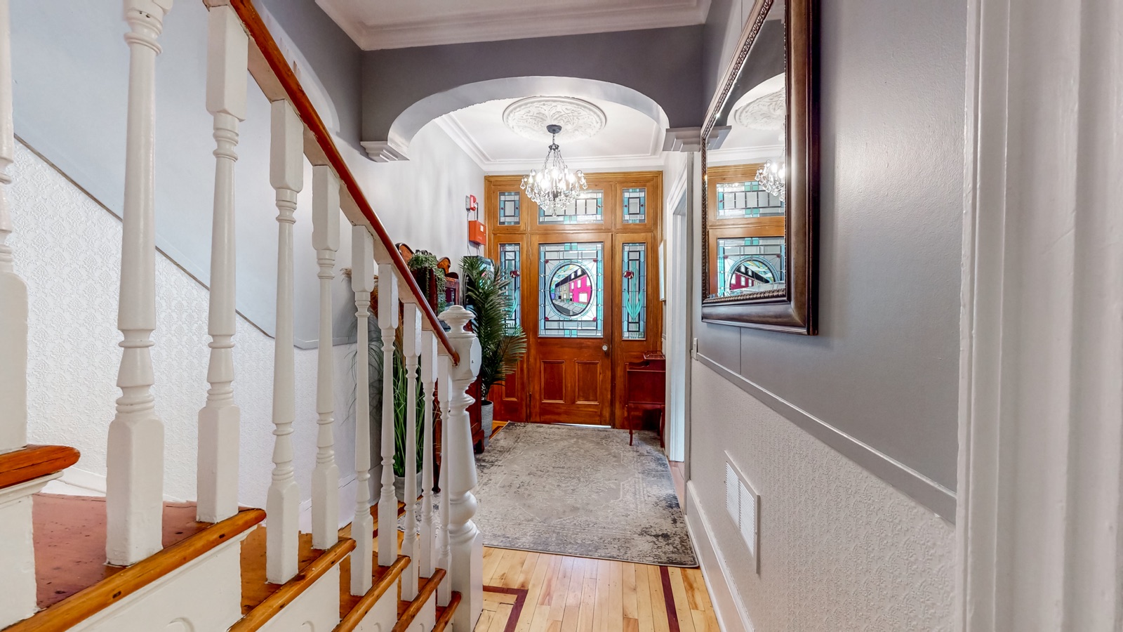 Original staircase and stained-glass front door